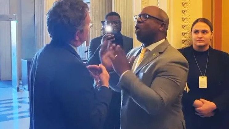 Rep. Jamaal Bowman, D-N.Y., speaks about gun violence to Rep. Thomas Massie, R-Ky., from left, at the U.S. Capitol