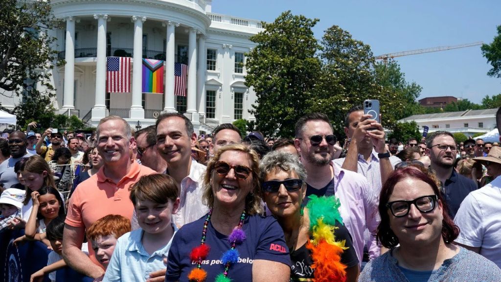 People listen as President Joe Biden speaks at a Pride Month celebration on the South Lawn of the White House